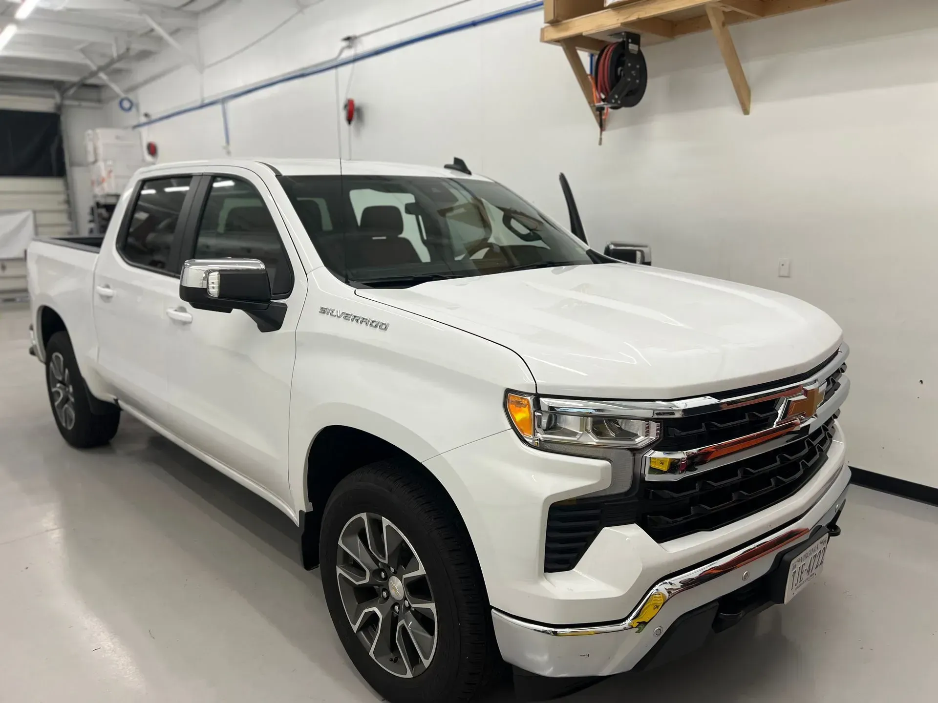 White Chevrolet Silverado truck parked inside a garage.