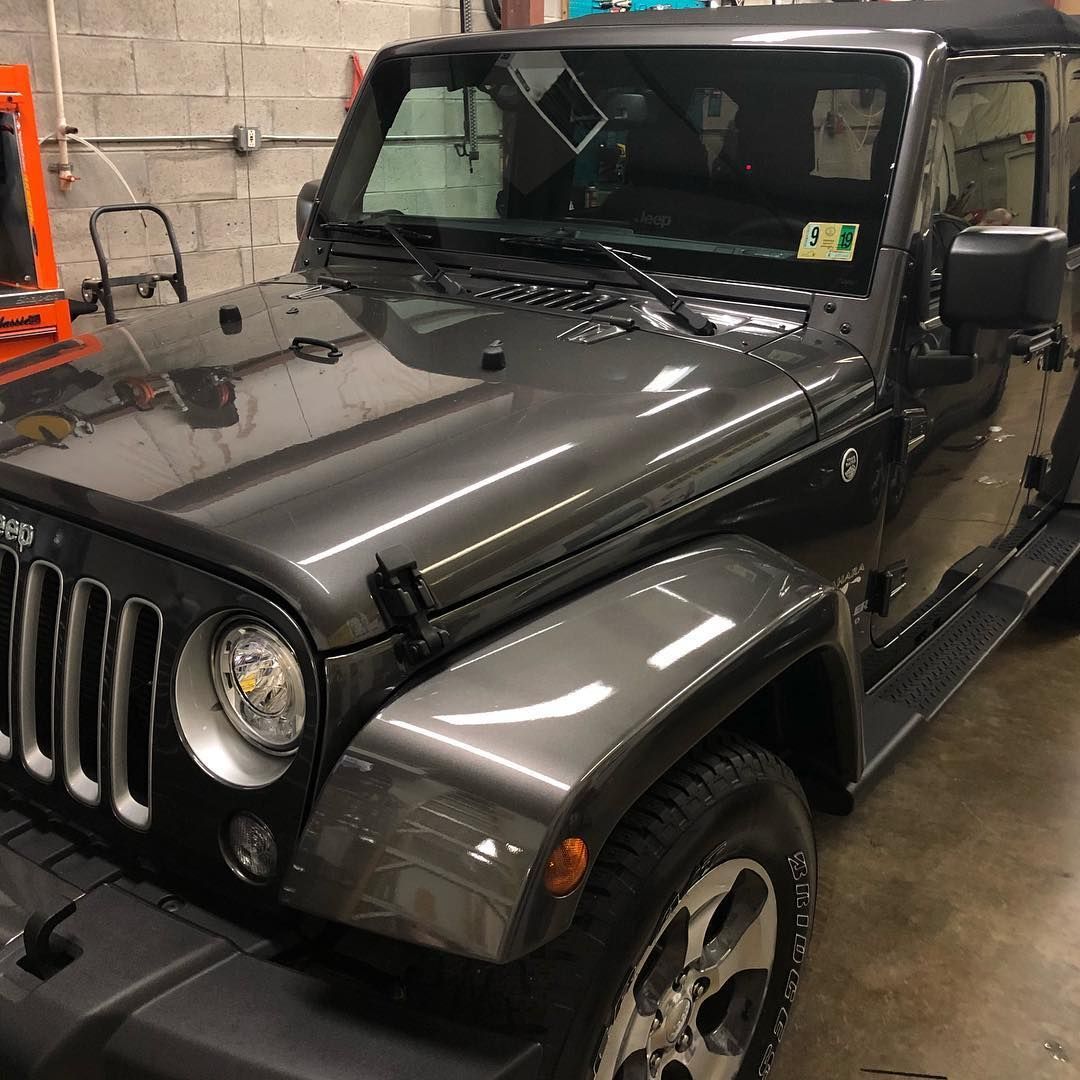 Gray Jeep Wrangler parked inside a building.