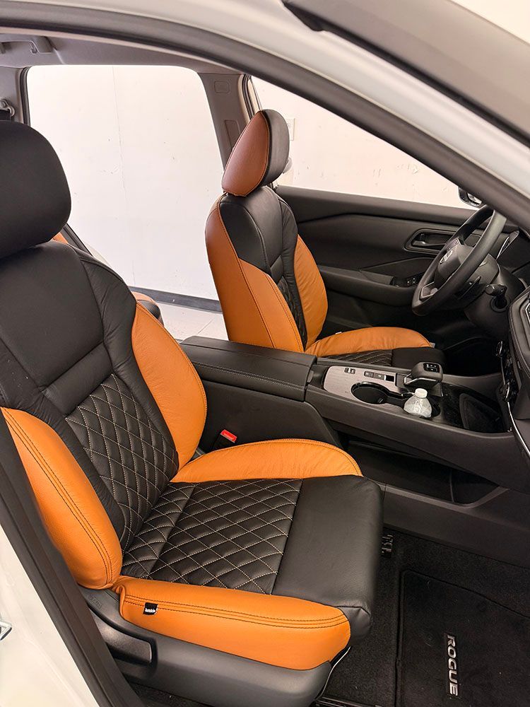 Interior of a car with black and tan leather seats.