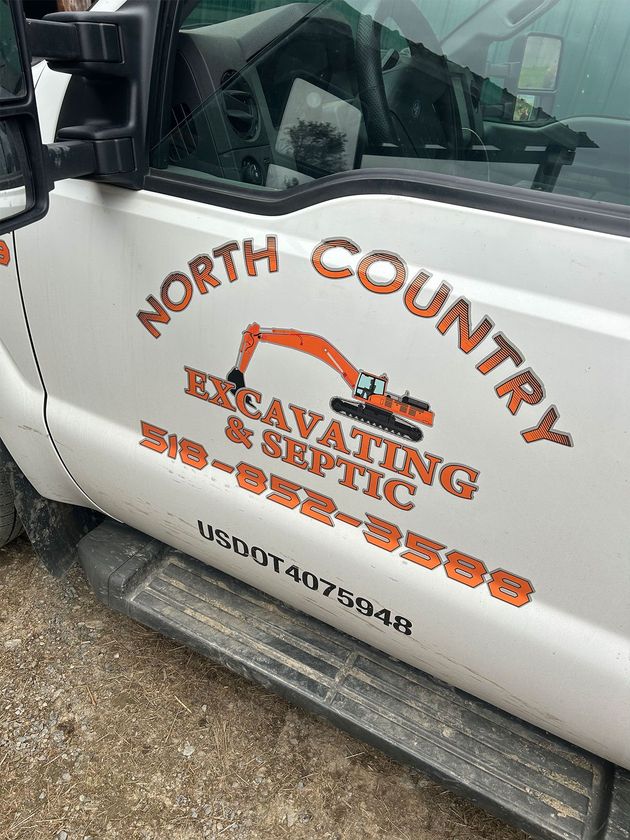 White truck door with orange logo: