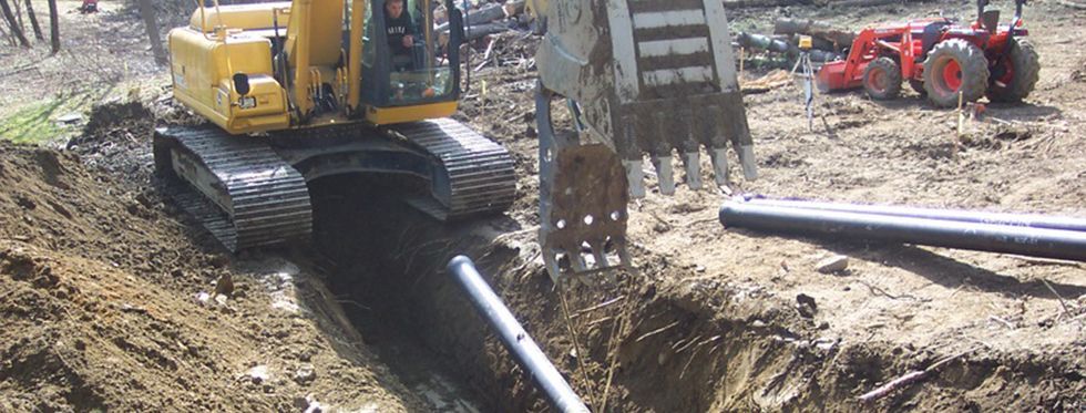 Underground pipe installation by tractor