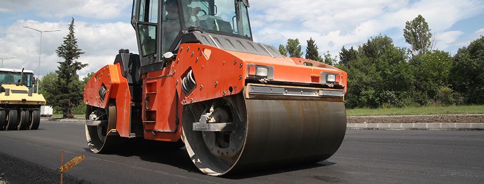 Large road roller paving a road