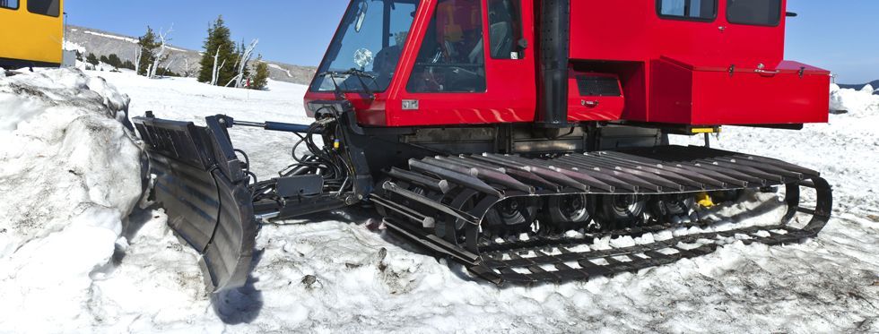 A snow plows machines removing snow