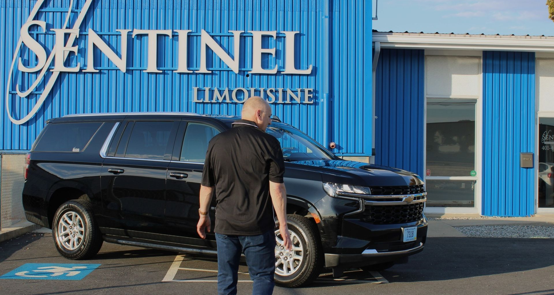 Man walks toward black SUV in front of