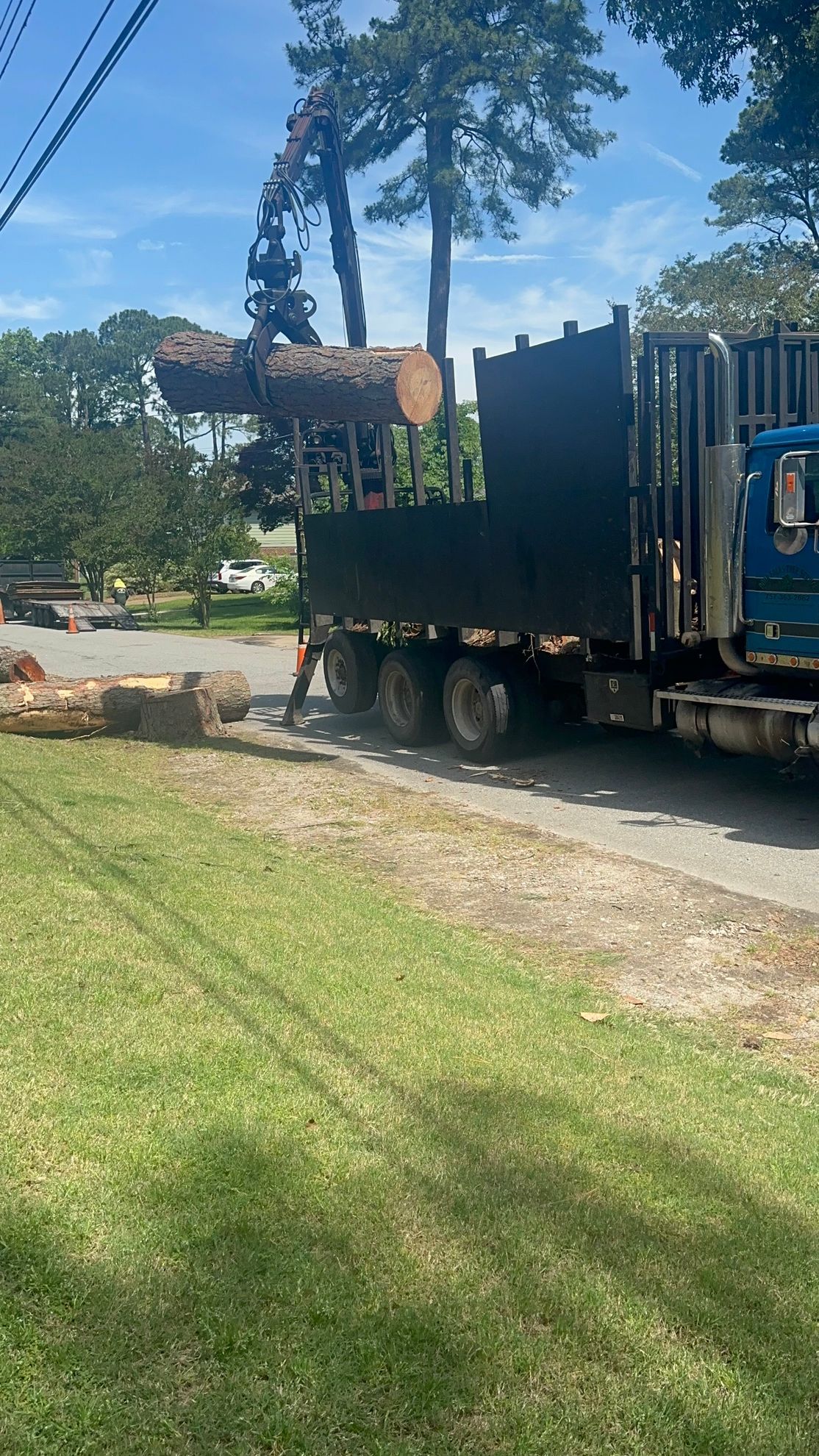 Poor Folks Tree Service truck loading logs