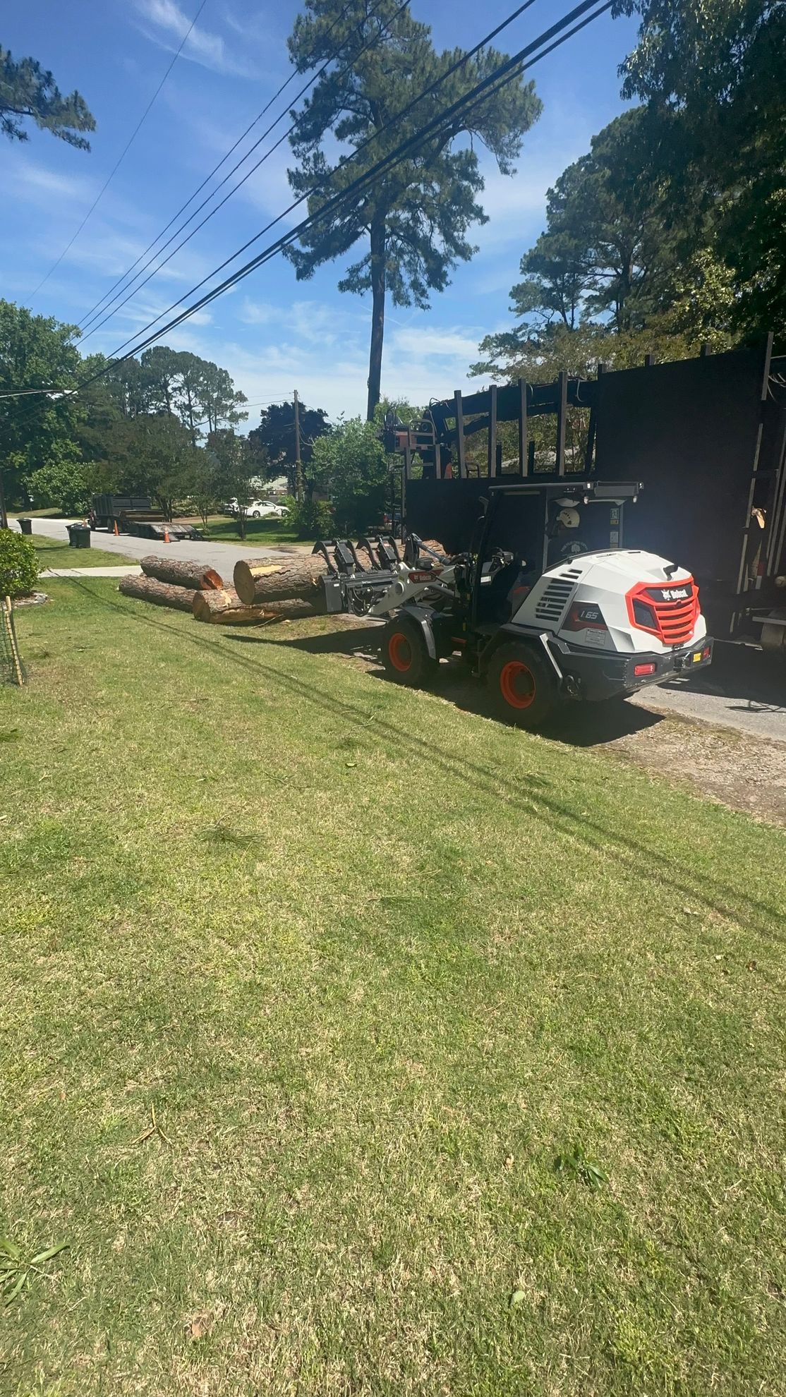 Rear view of a small white truck of Poor Folks Tree Service