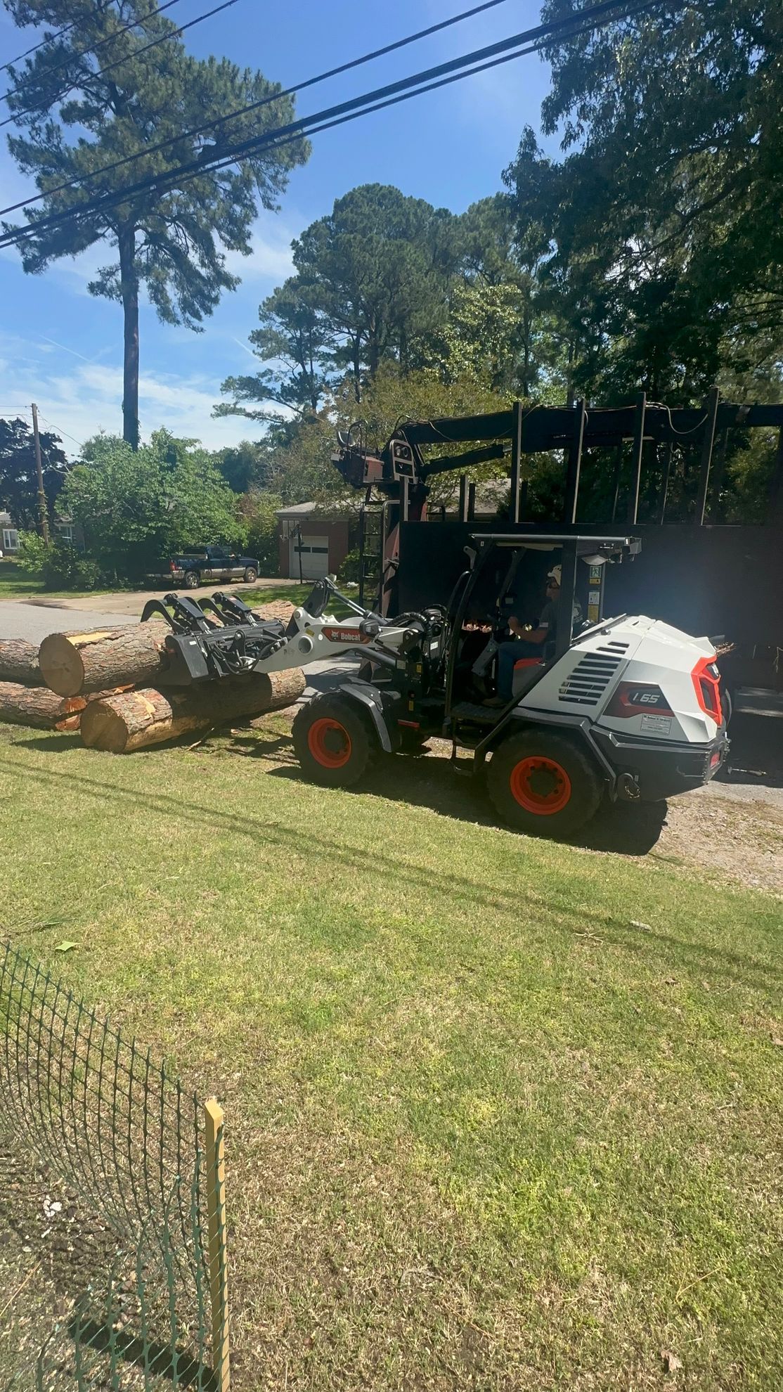 Side view of a small white truck of Poor Folks Tree Service