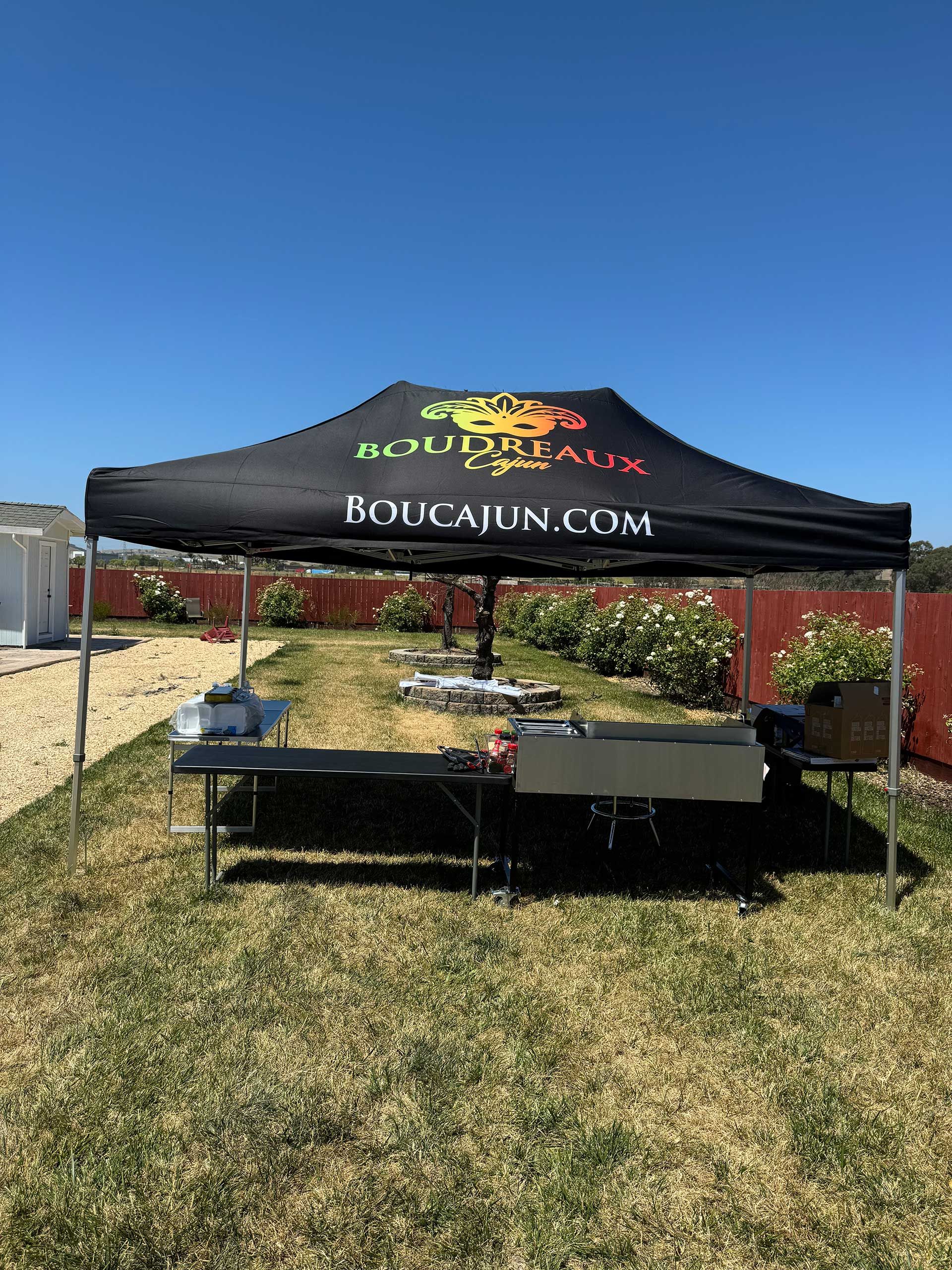 A black tent in the middle of a grassy field