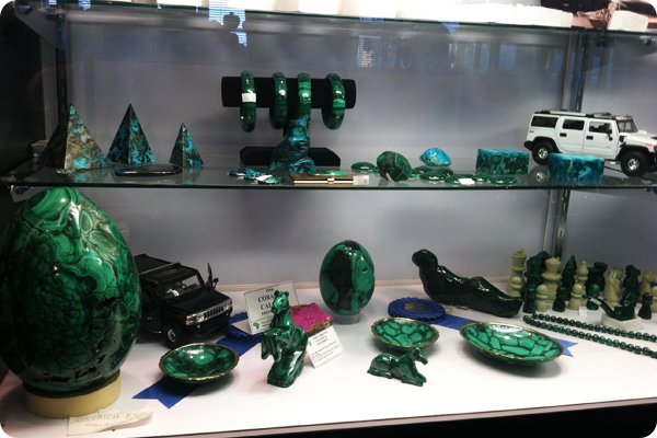 A display case filled with green items including a jeep