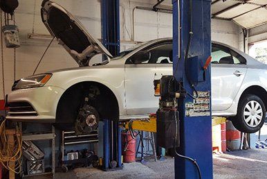 Auto mechanic checking a car