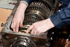 Mechanic repairing a transmission