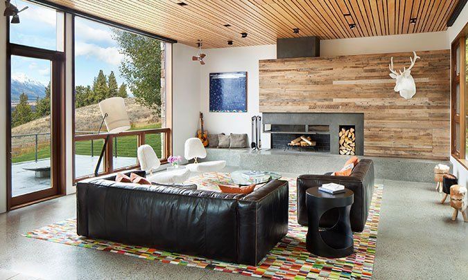 A living room with a couch , chairs , and a fireplace.