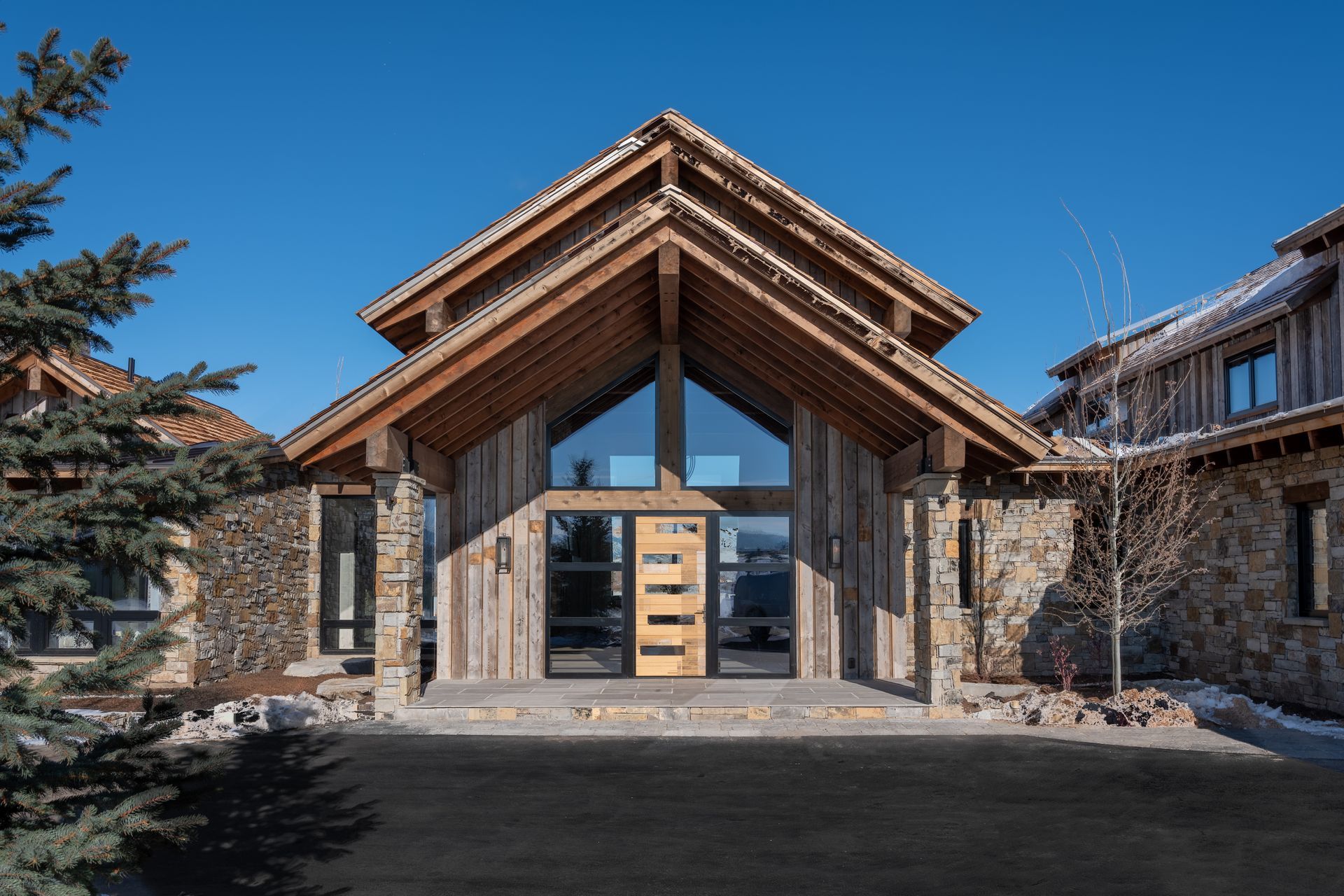A large house with a wooden roof and a lot of windows