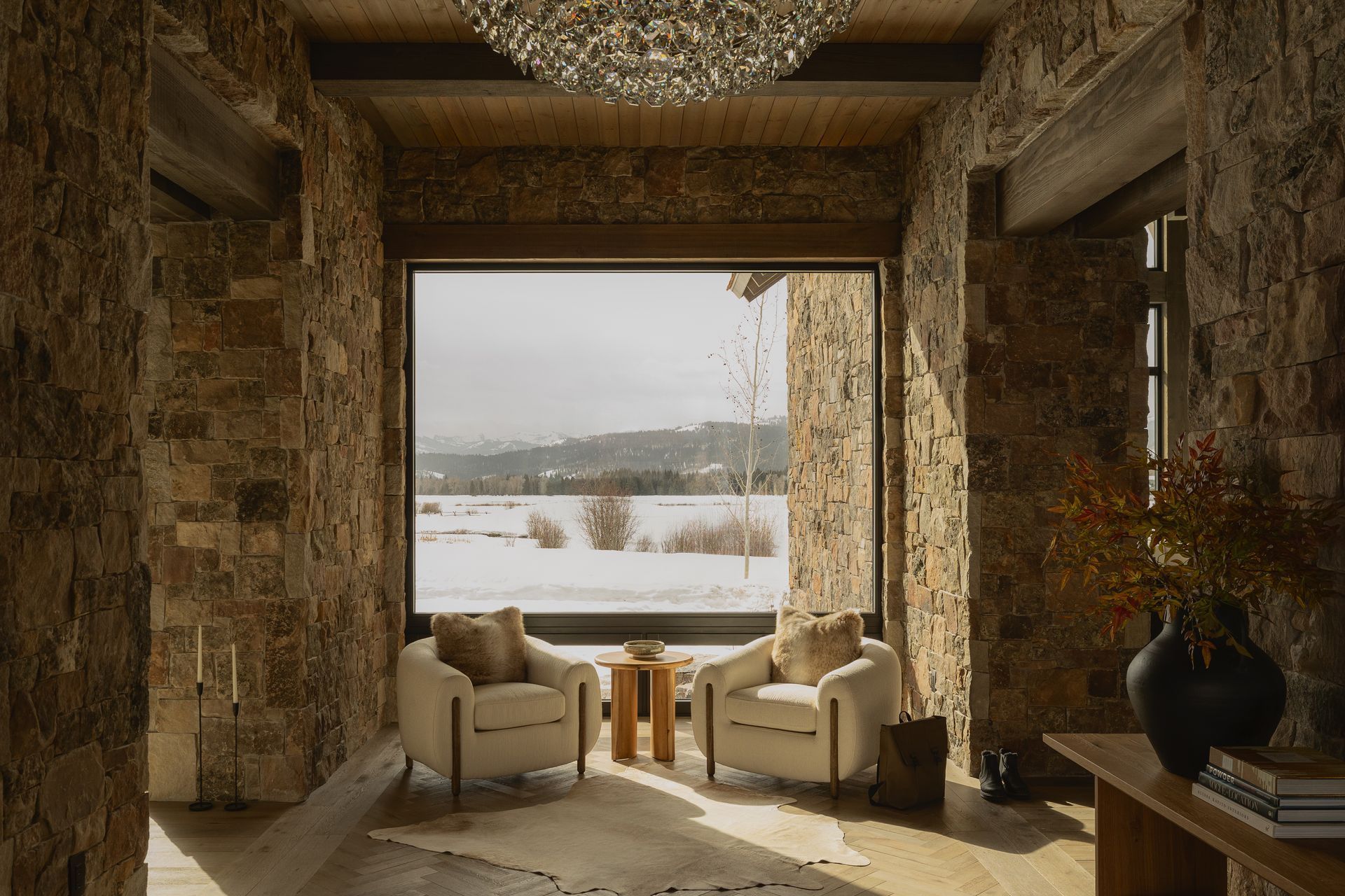 A living room with two chairs and a large window.