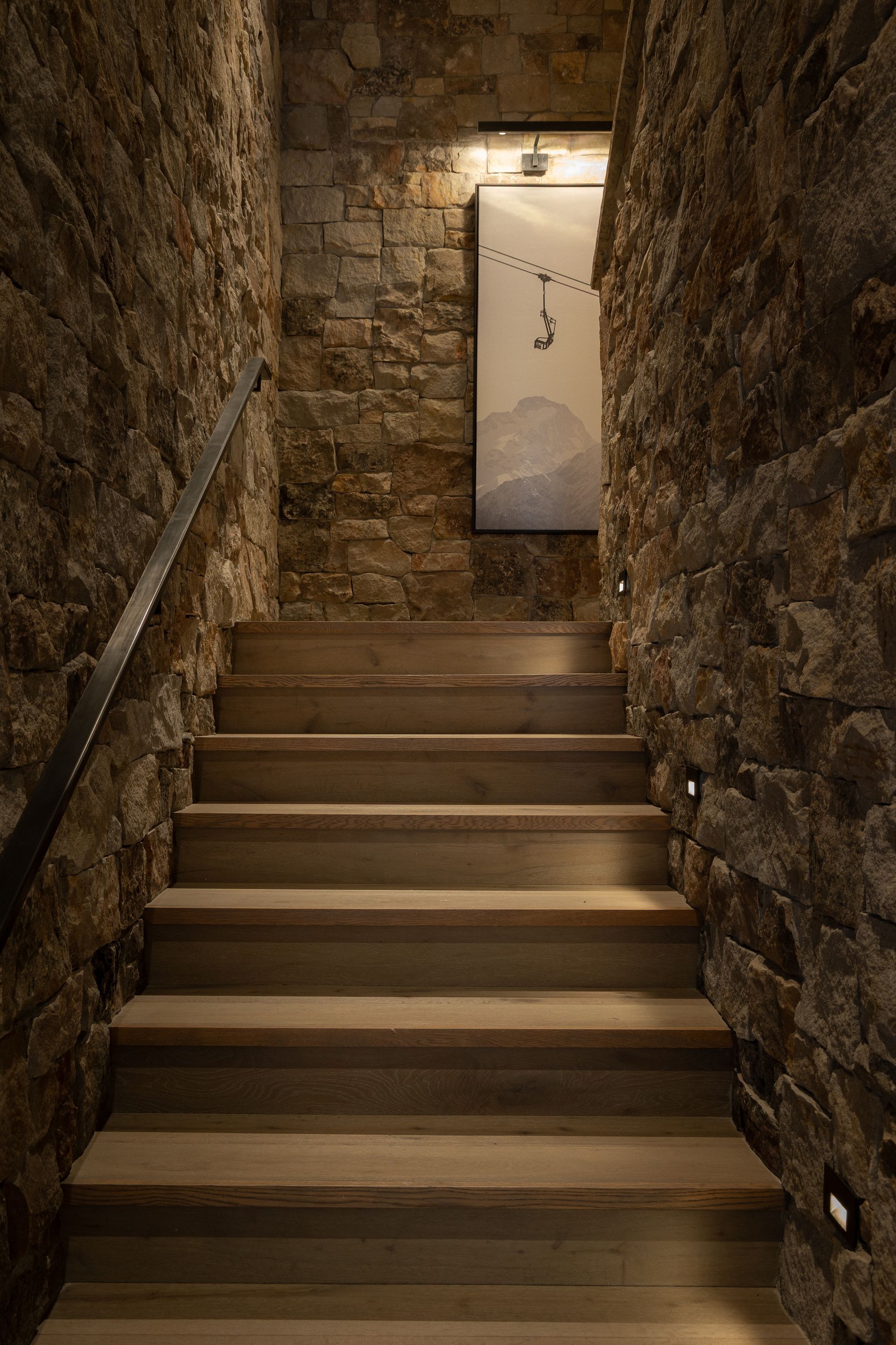A set of stairs leading up to a stone wall.