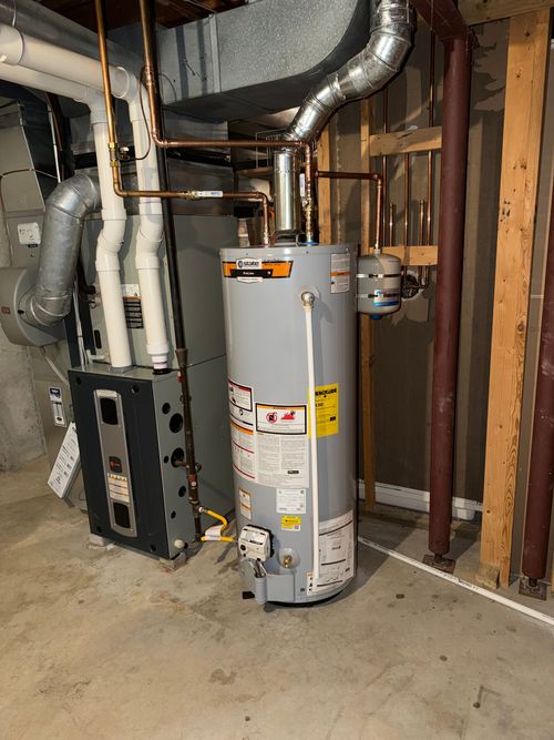Water heater and furnace in a basement.