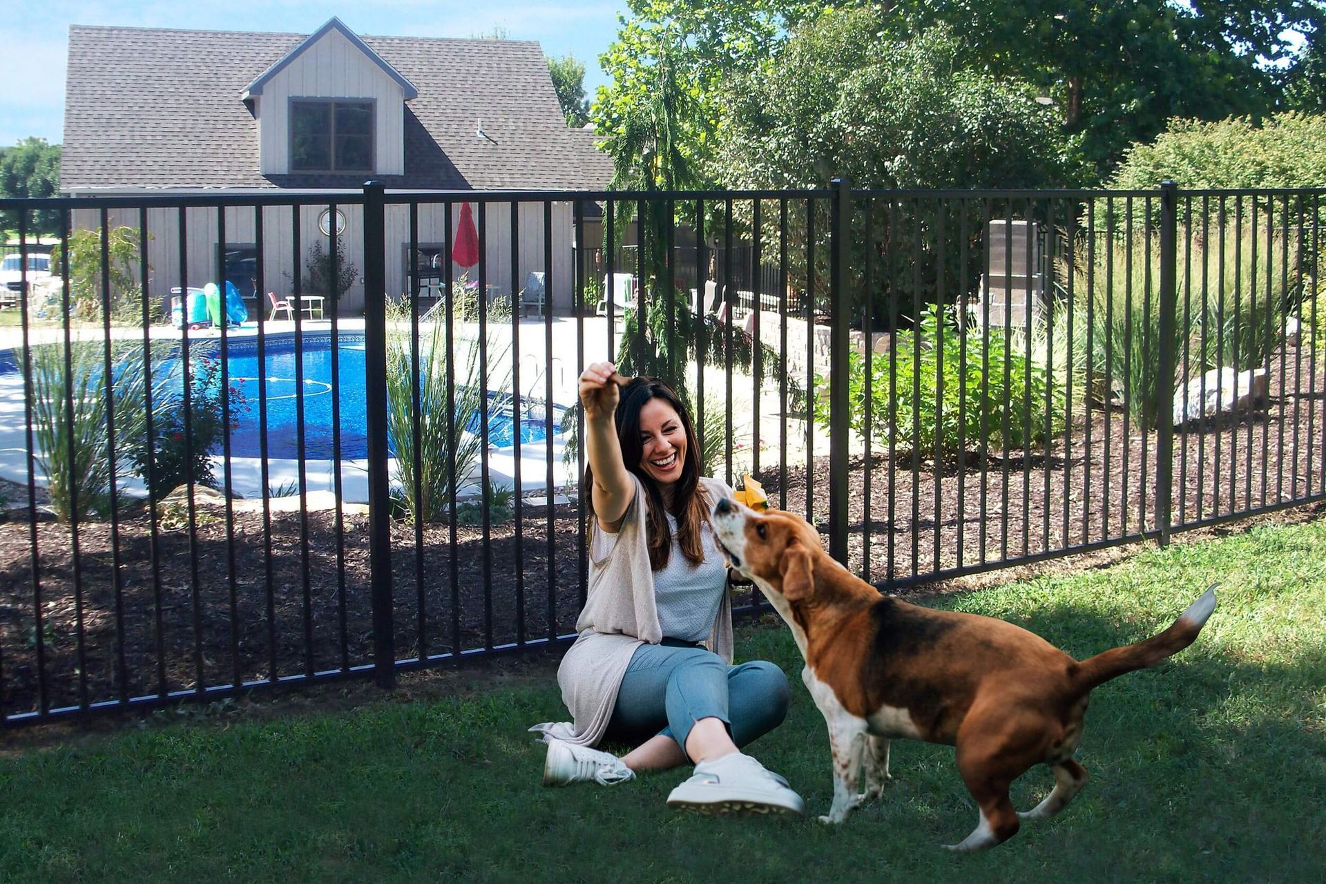 Aluminum pool fence with dog and owner playing