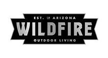 Wildfire Outdoor Living logo: black and silver text on a geometric shape, 