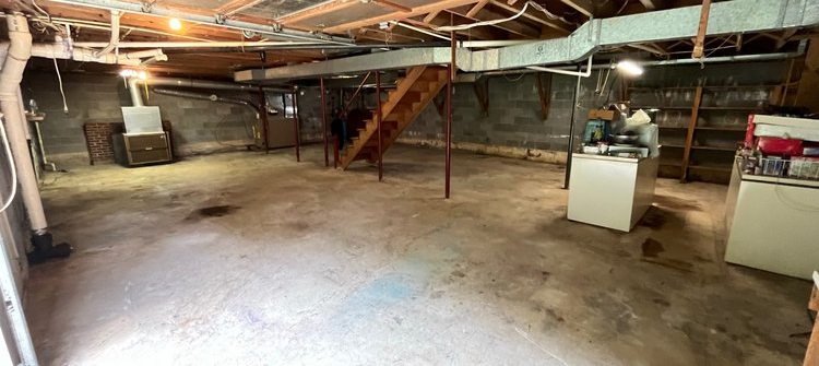 There is a staircase in the basement of a house.