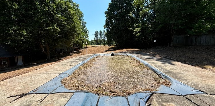 A dirt road with trees on the side of it
