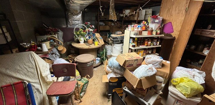 A room filled with lots of boxes and a chair.