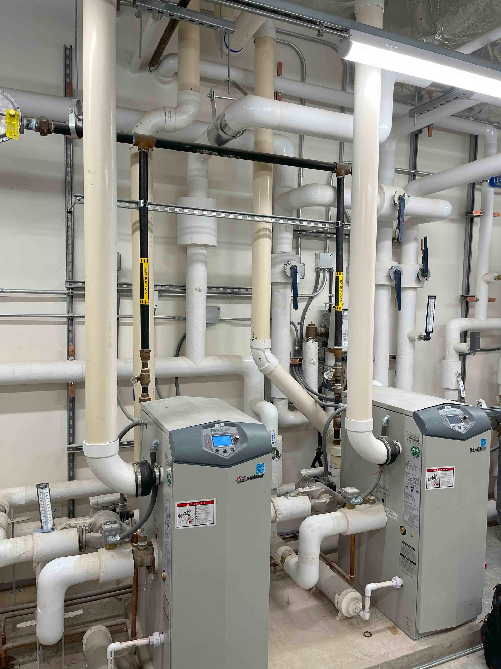 A room filled with lots of pipes and boilers.