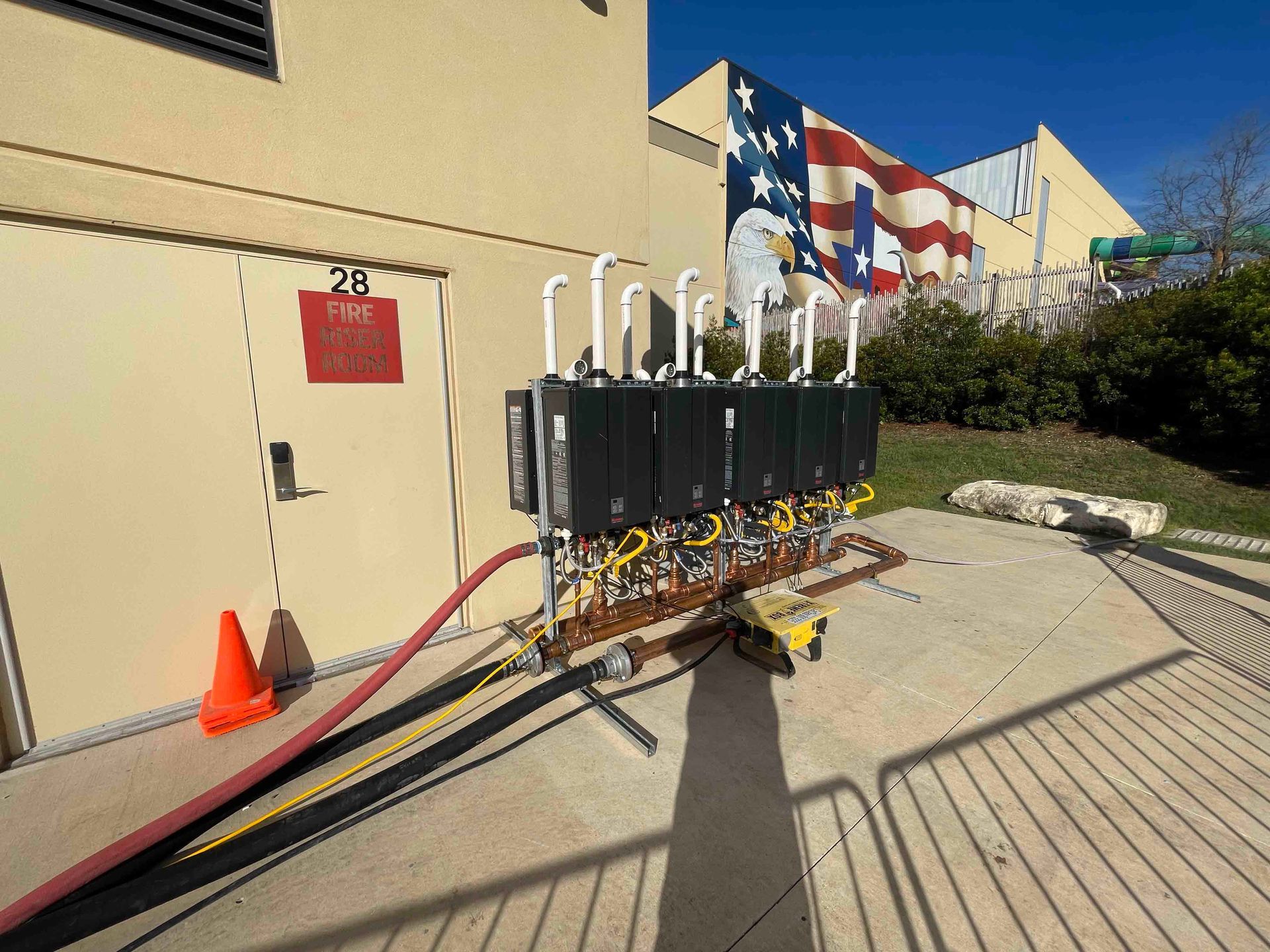 A large american flag is hanging on the side of a building