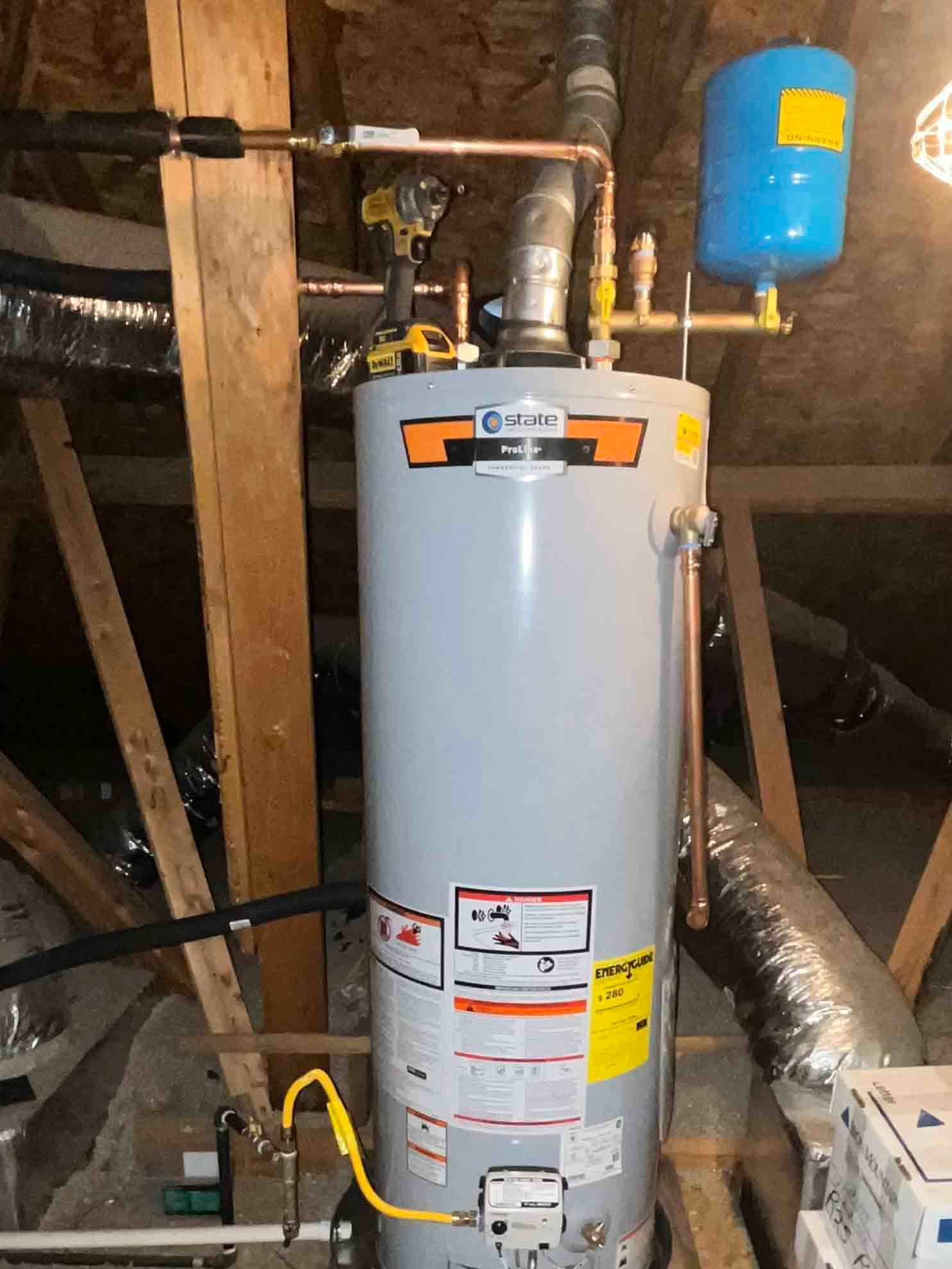 A water heater is sitting in the attic of a house.