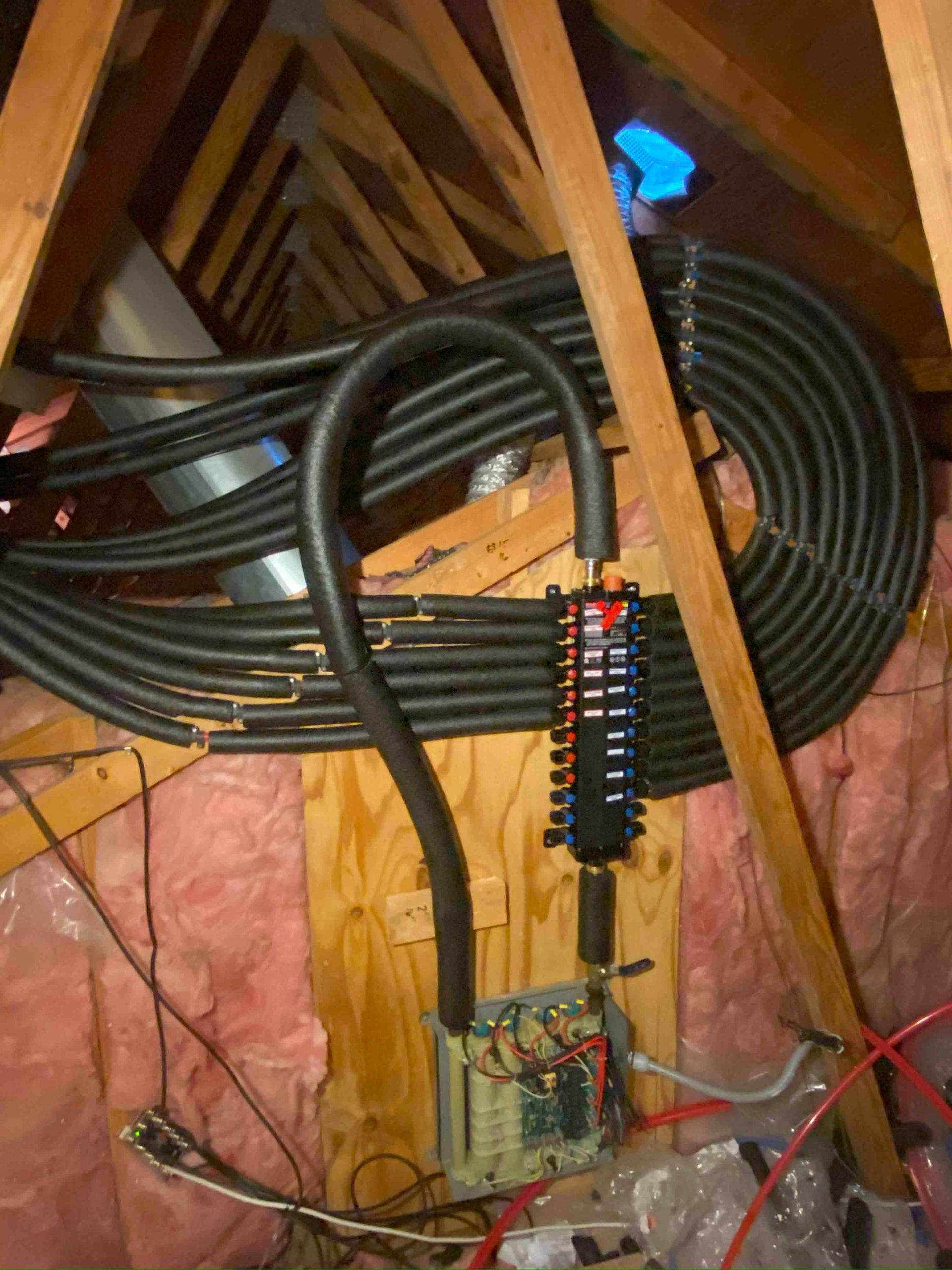 A bunch of wires are hanging from the ceiling of a building