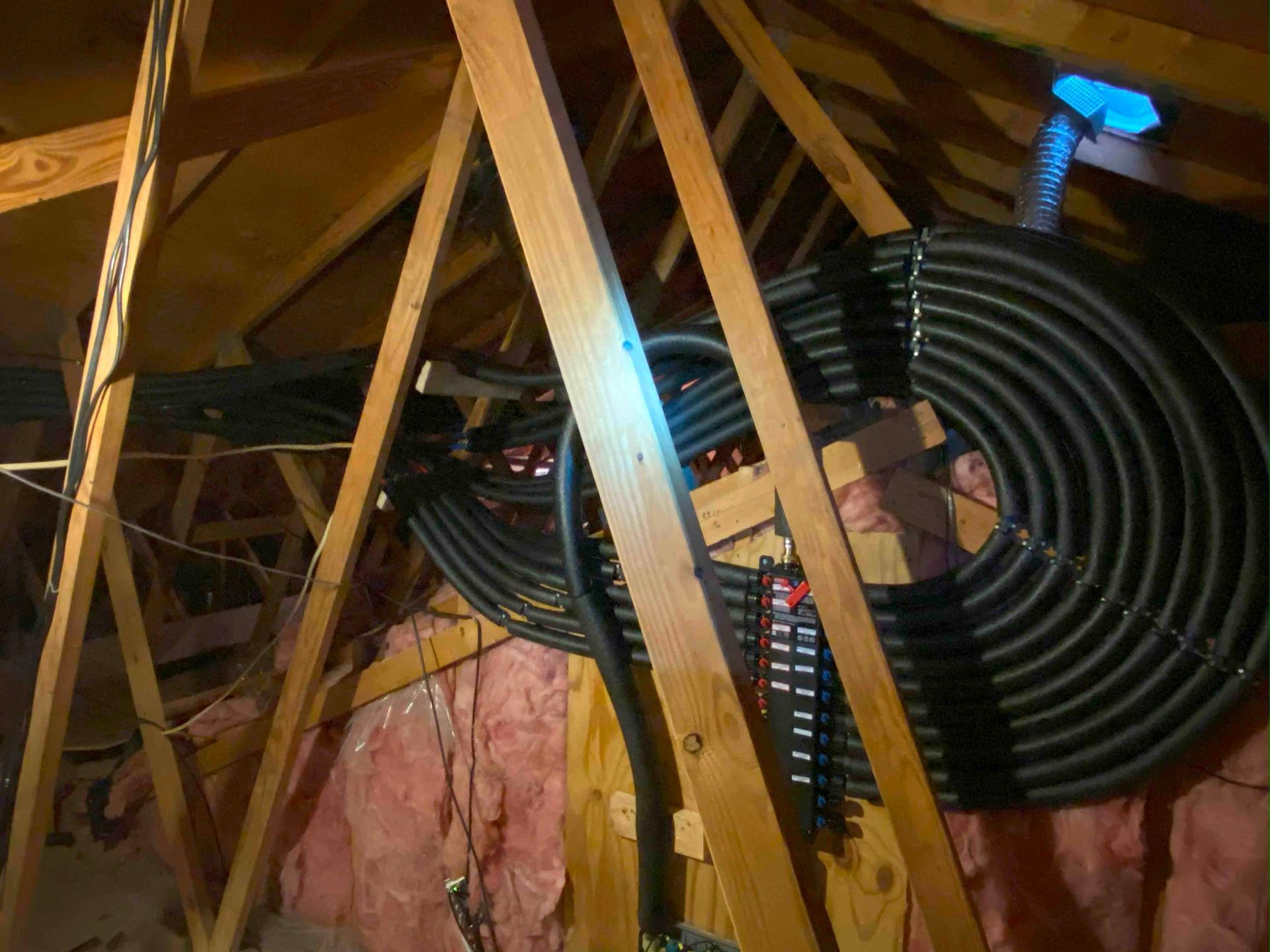 A bunch of wires are hanging from the ceiling of a building