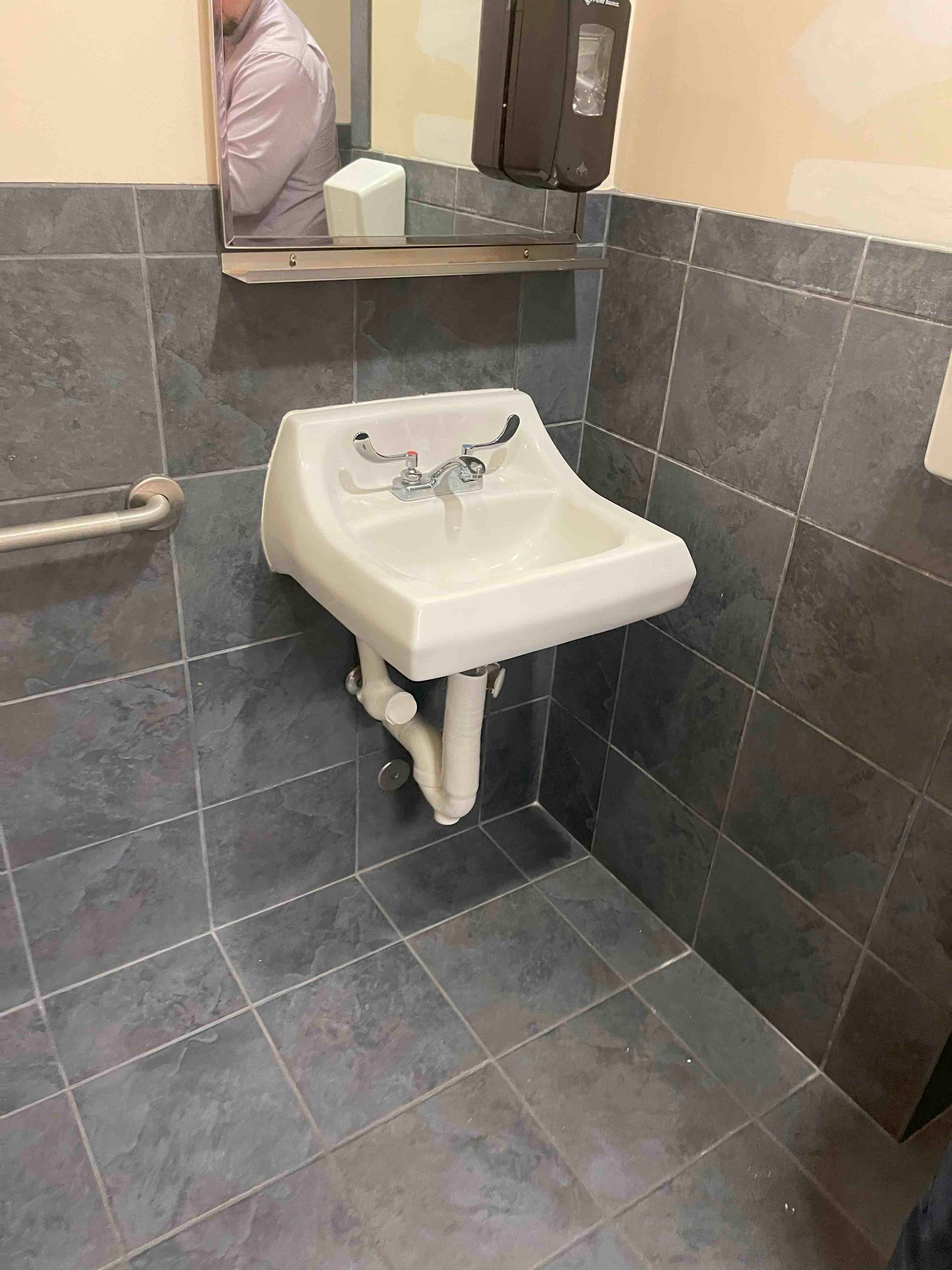 A bathroom with a sink and a mirror.