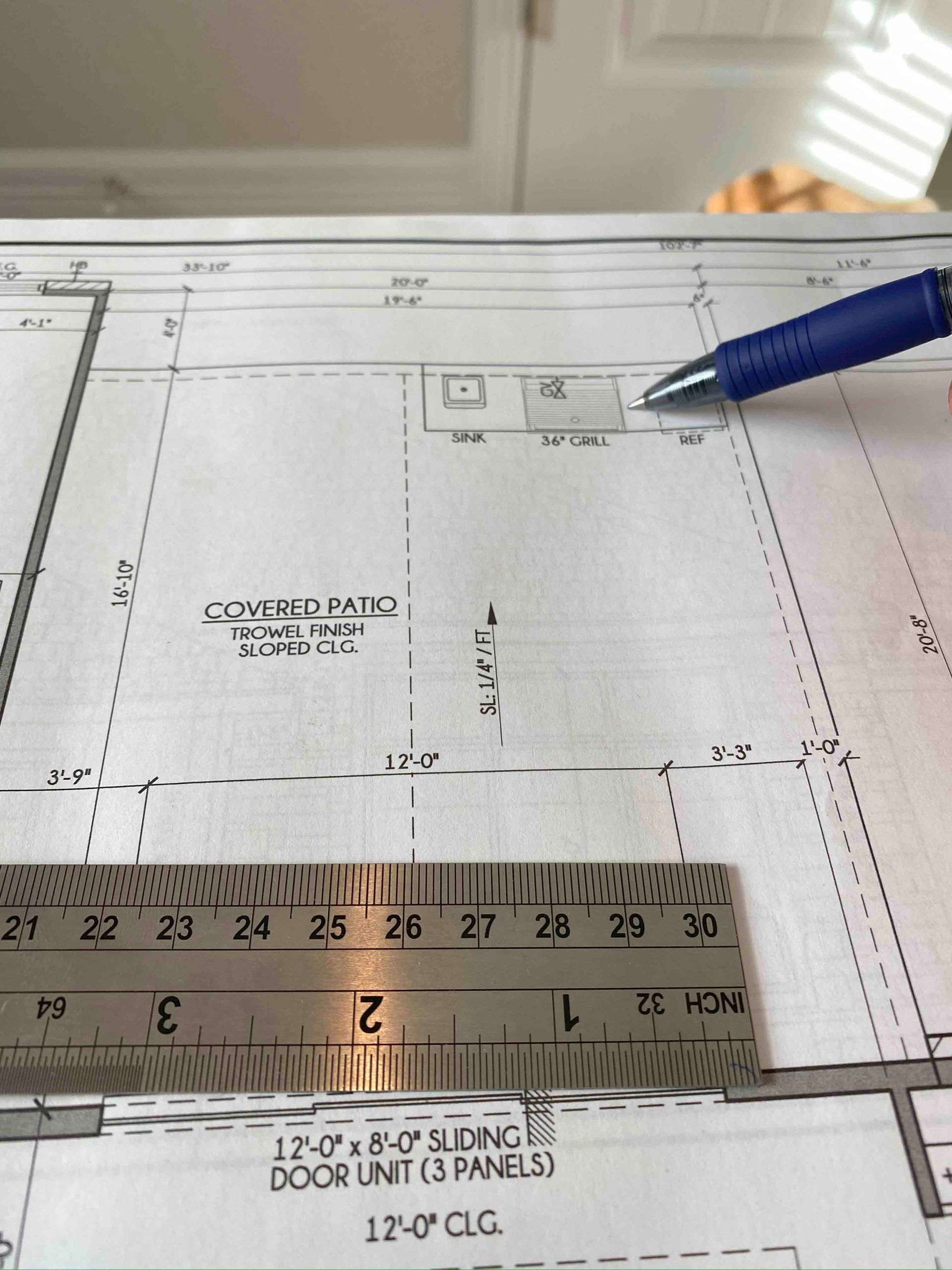A ruler is laying on top of a drawing of a building
