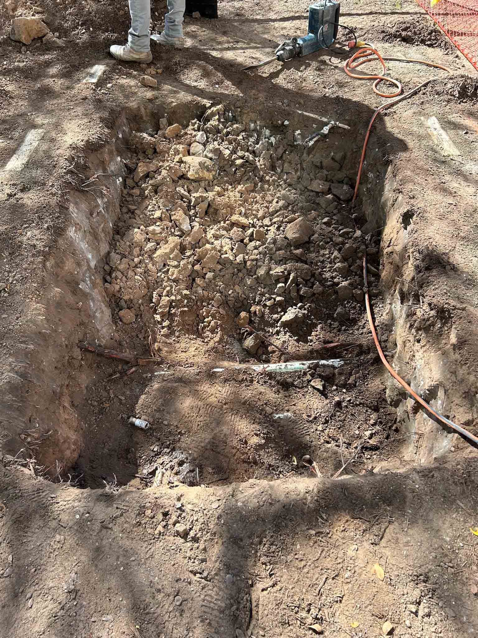 A person is digging a hole in the ground.