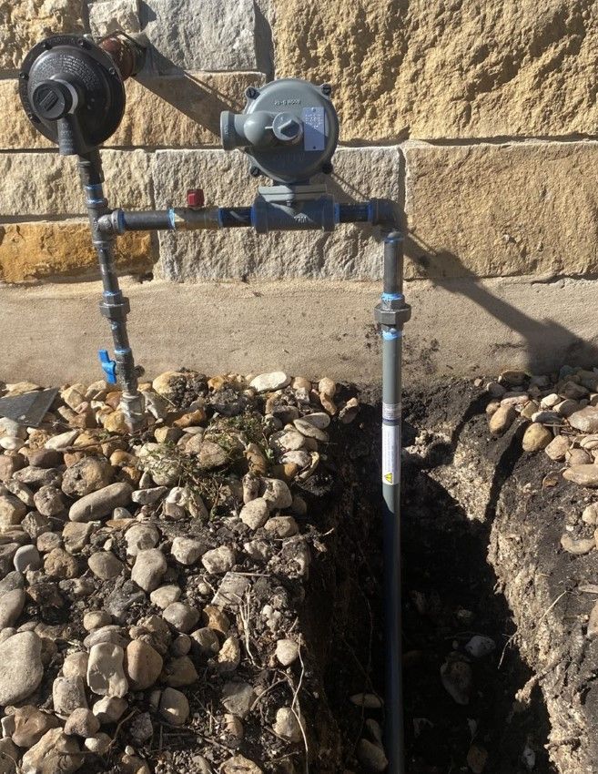 A room with a lot of pipes and gauges on the wall