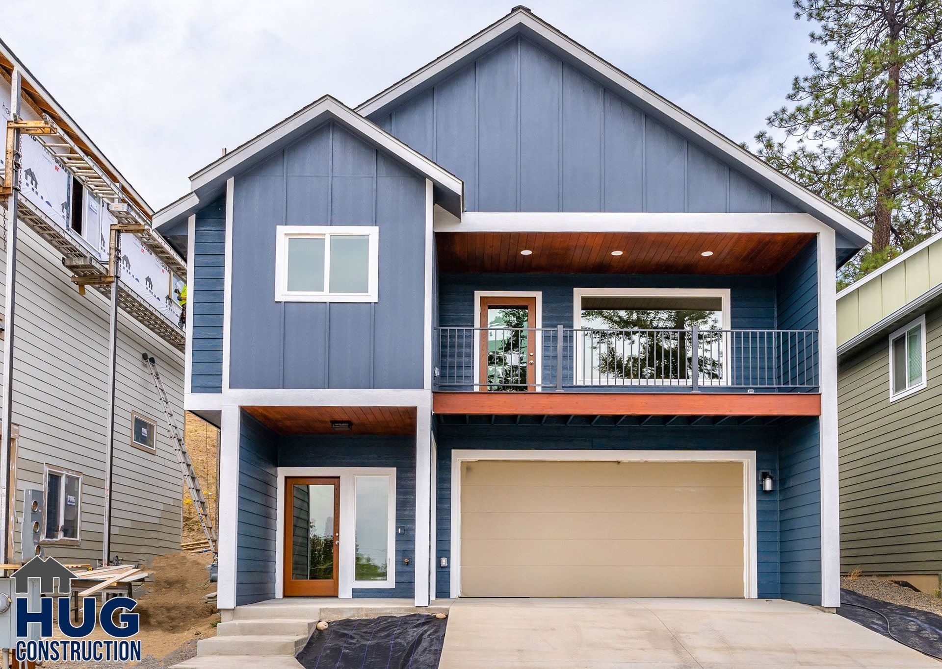 A blue house with a garage and balcony