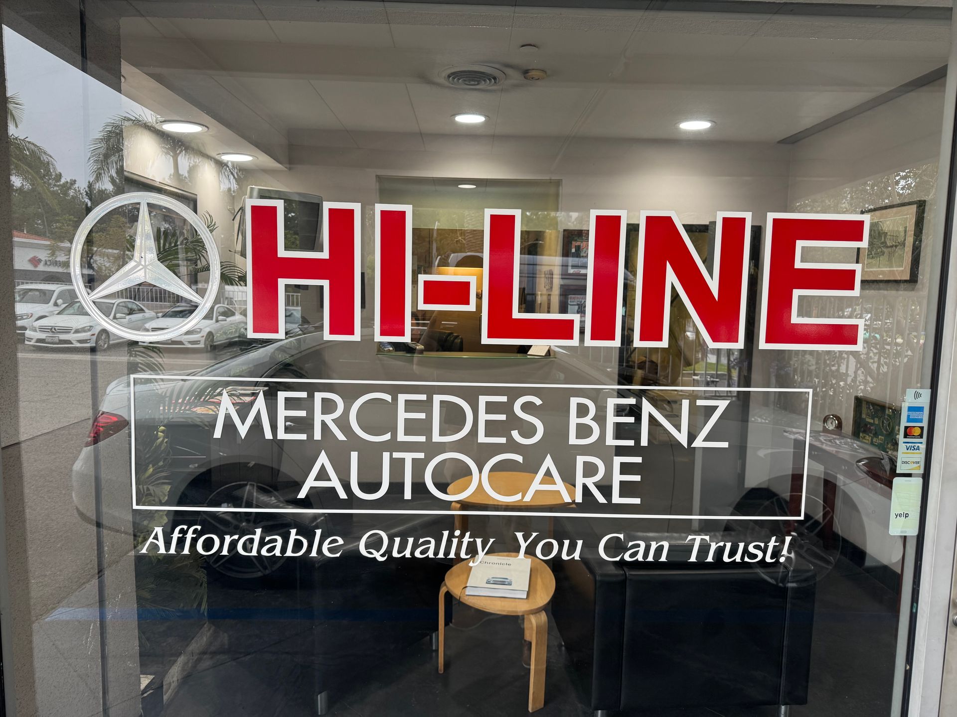HI-LINE Mercedes Benz Autocare storefront sign in red and white on glass door
