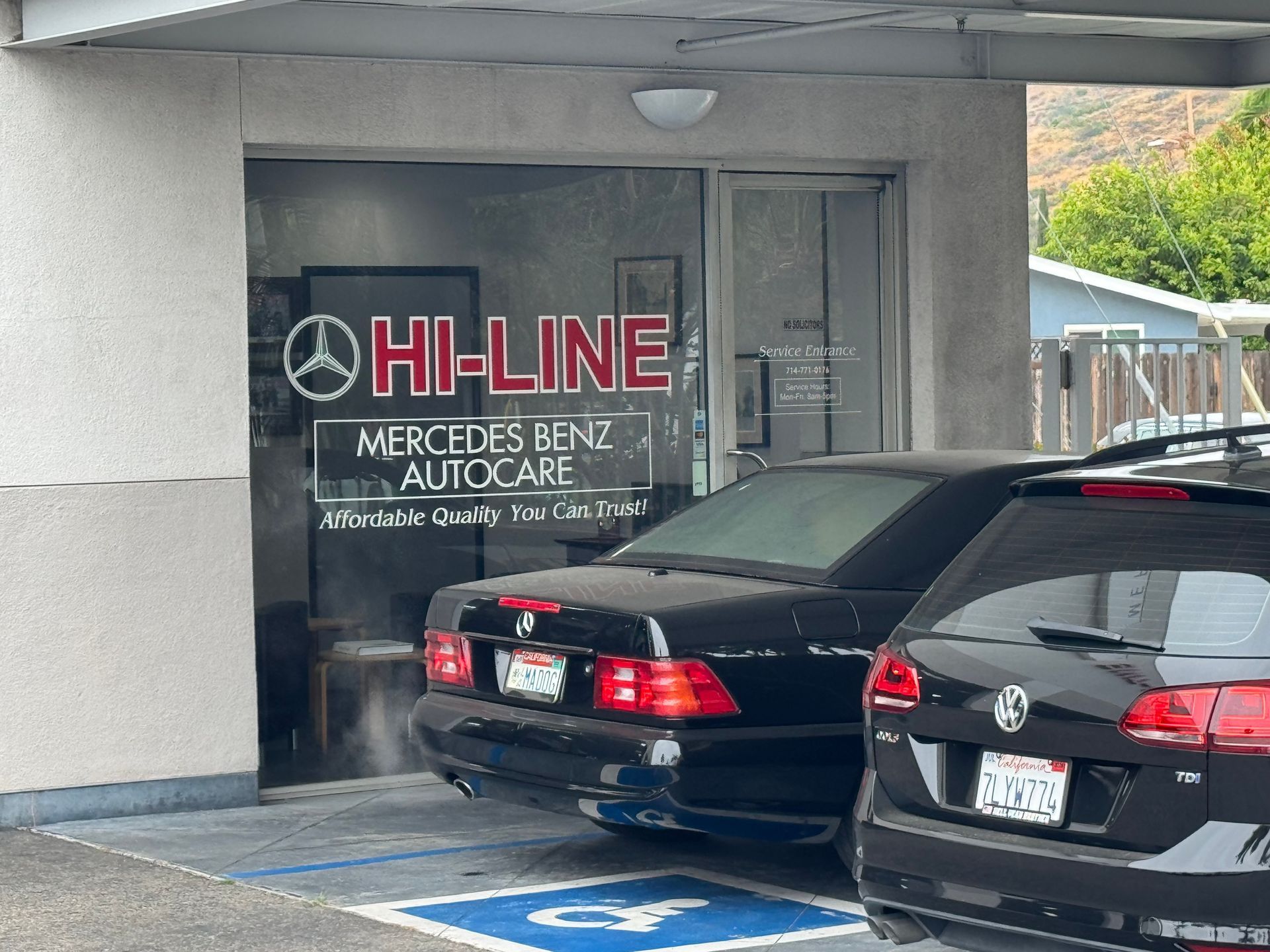 Cars parked outside Hi-Line Mercedes-Benz dealership entrance