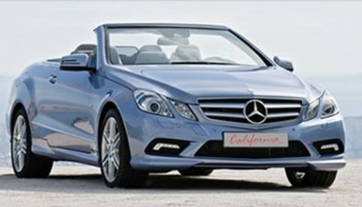 Blue Mercedes-Benz convertible parked on a white background, front view.