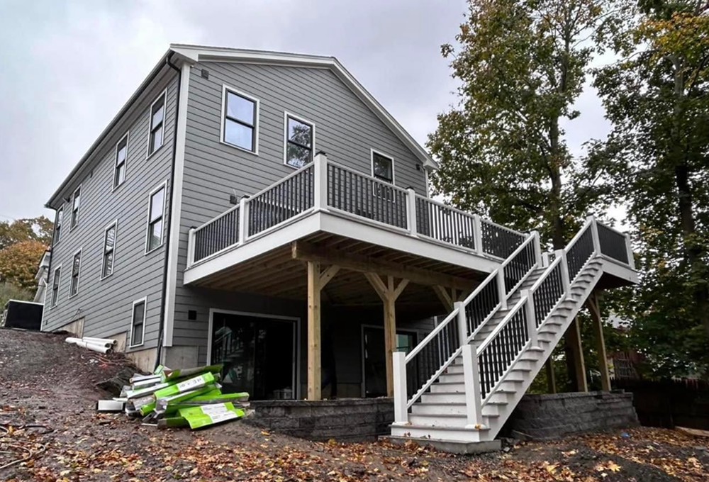 The back of a house with a large deck and stairs