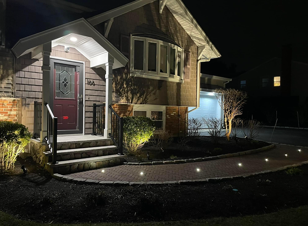 A house with a red door is lit up at night