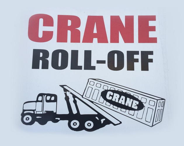 White roll-off truck with crane labeled “CRANE 11” parked outdoors near trees.