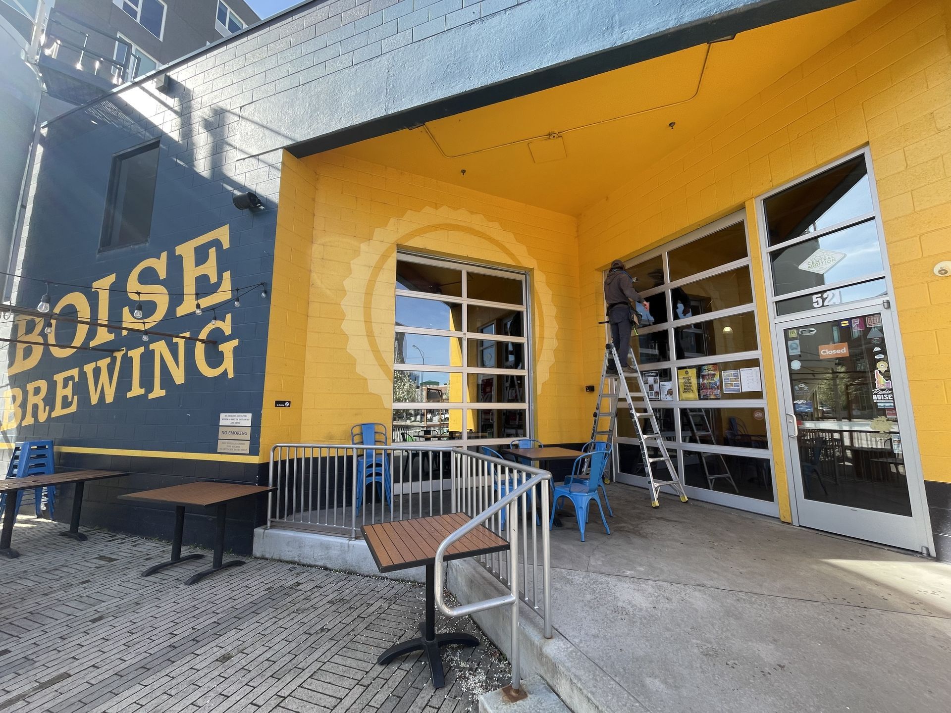 A yellow building with a sign that says house brewing