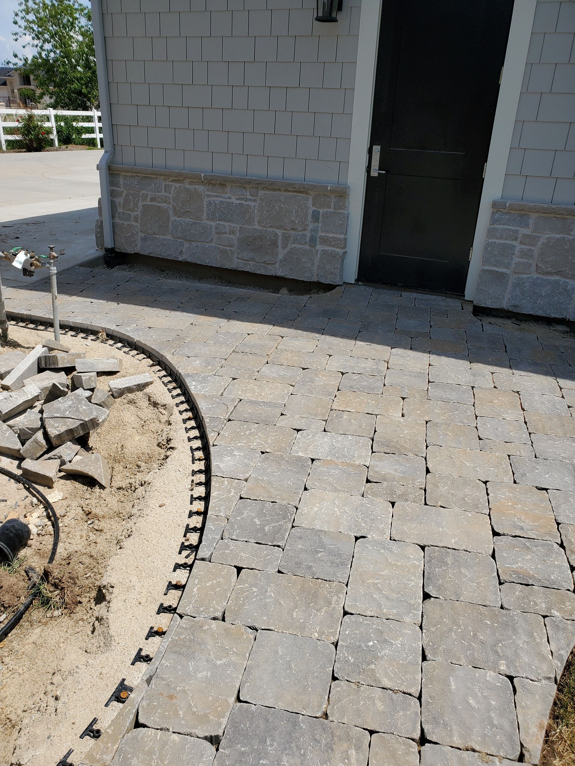 A brick walkway is being built in front of a brick building
