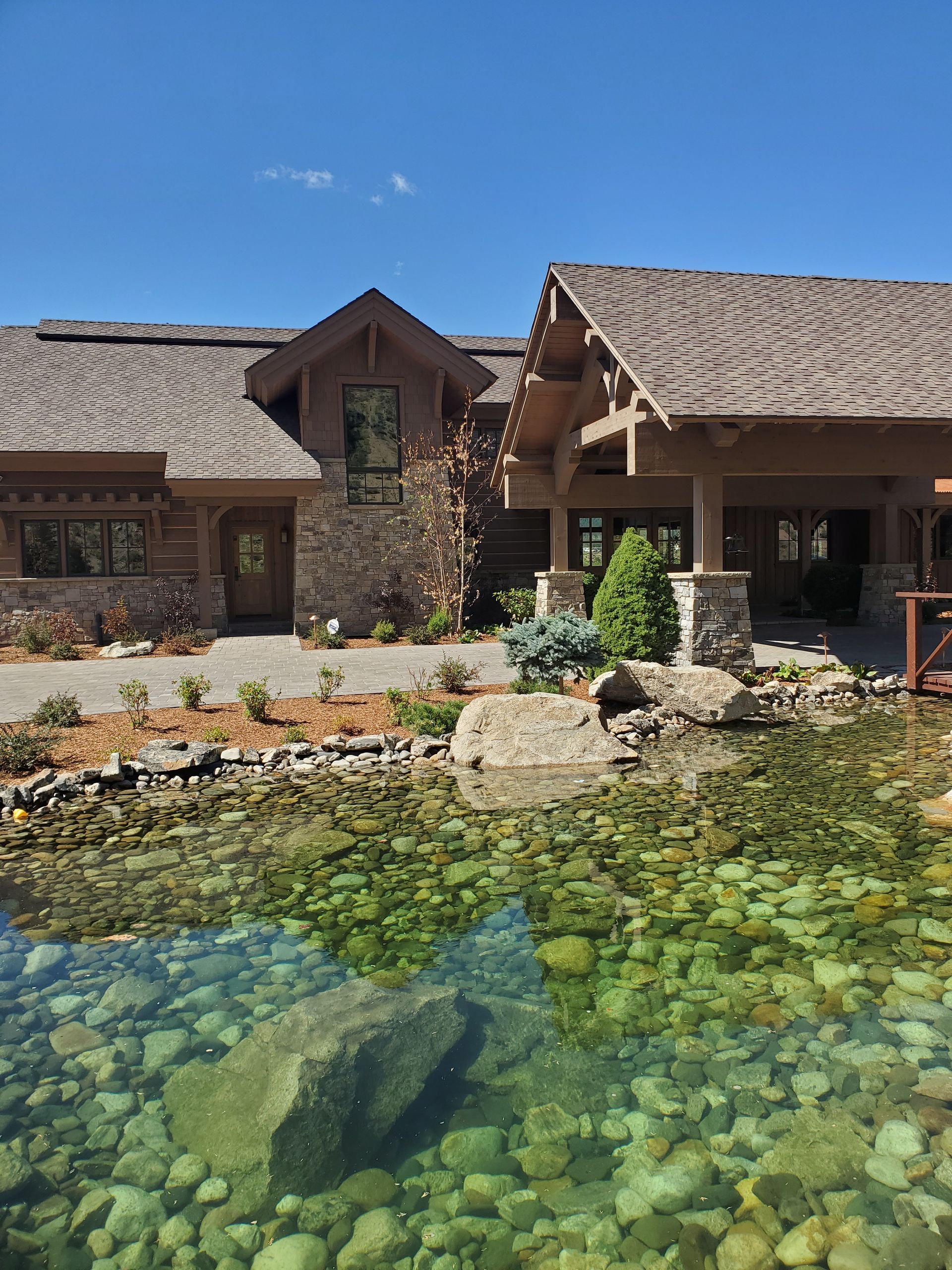 A large house with a pond in front of it