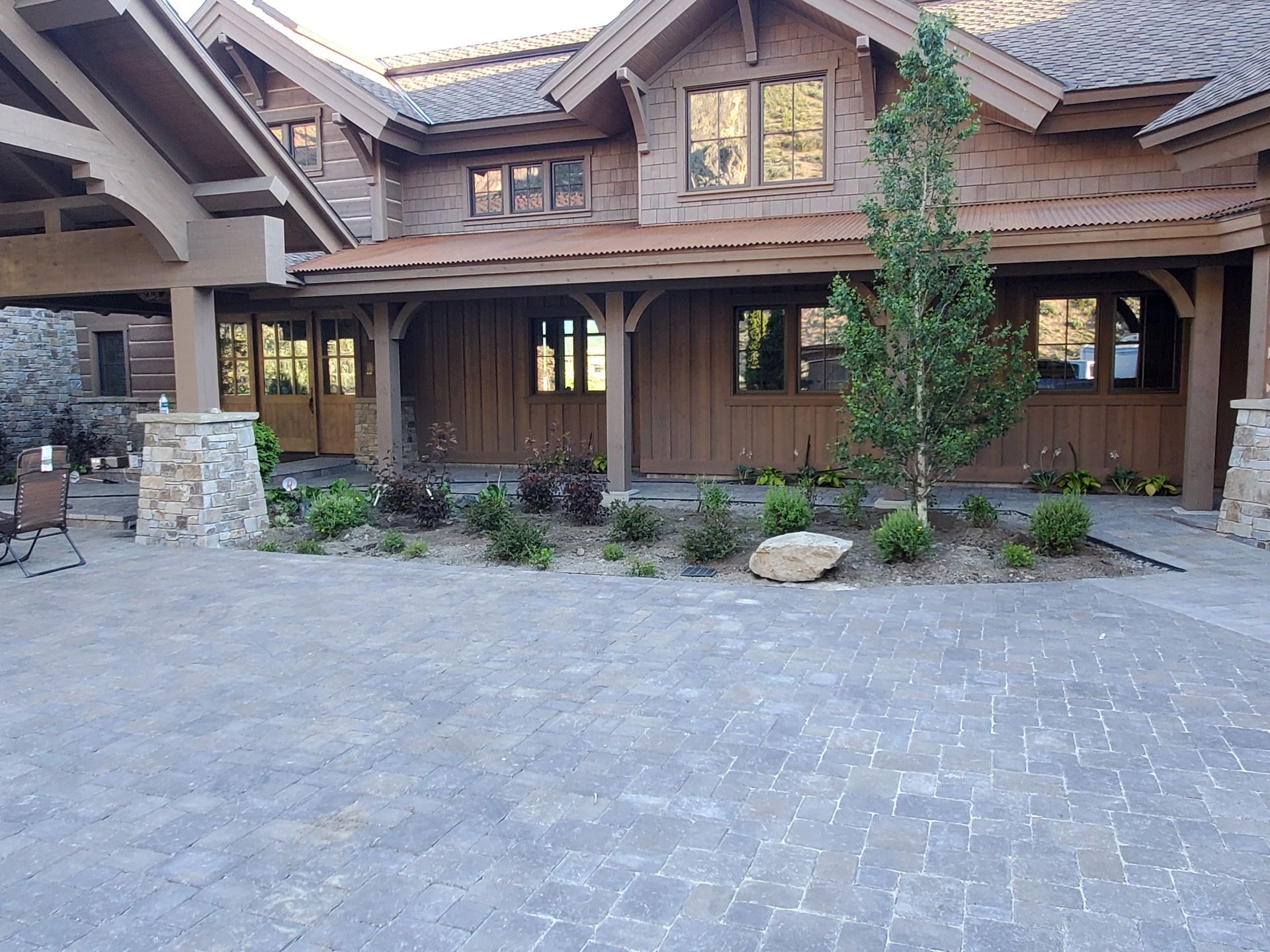 A large house with a brick driveway in front of it