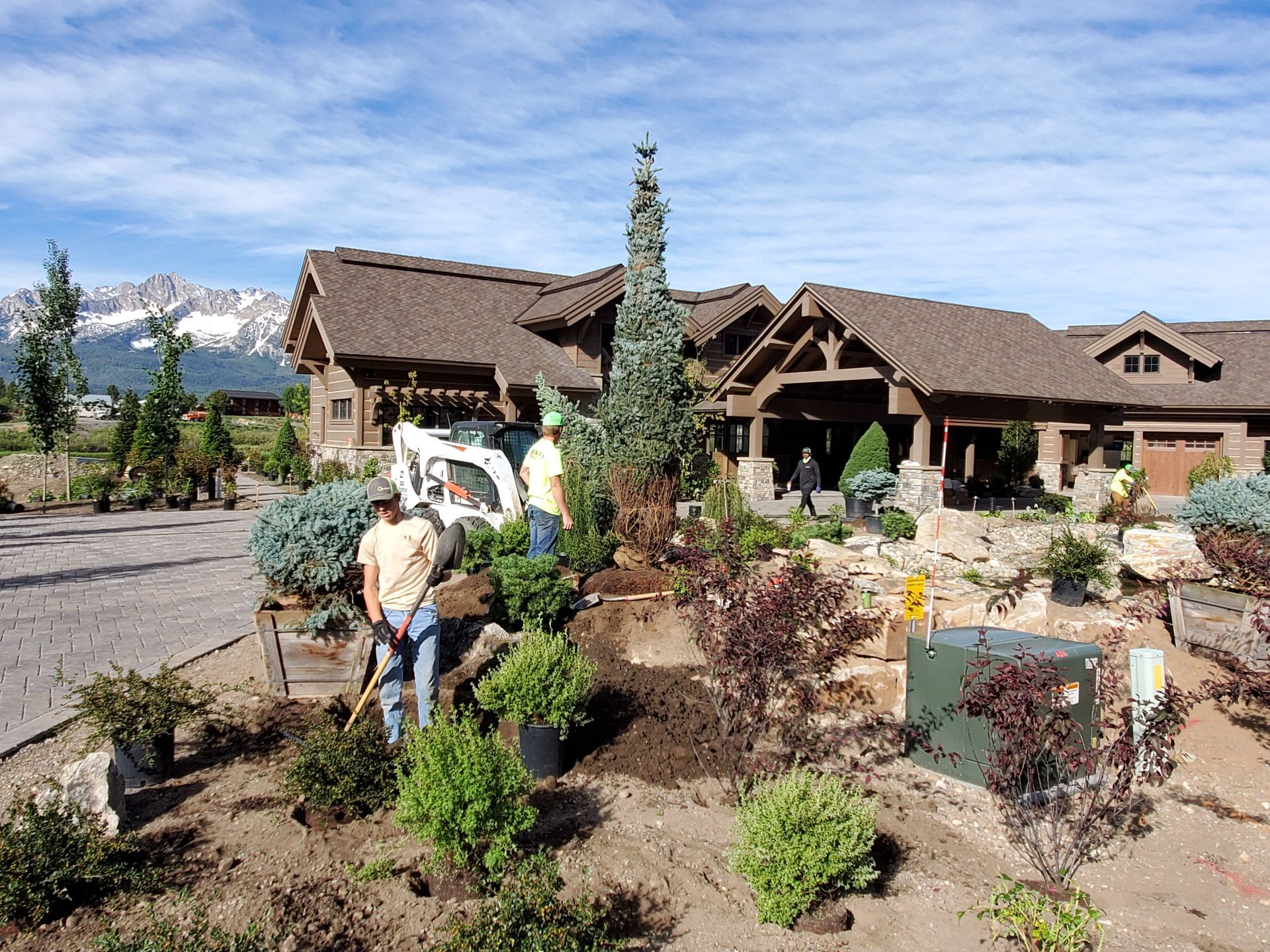 A group of people standing in front of a large house