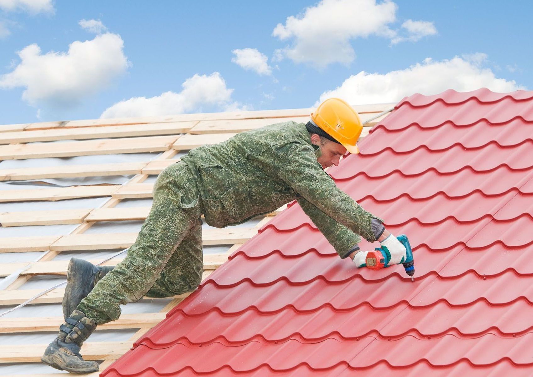 A man is working on a roof with a hammer.