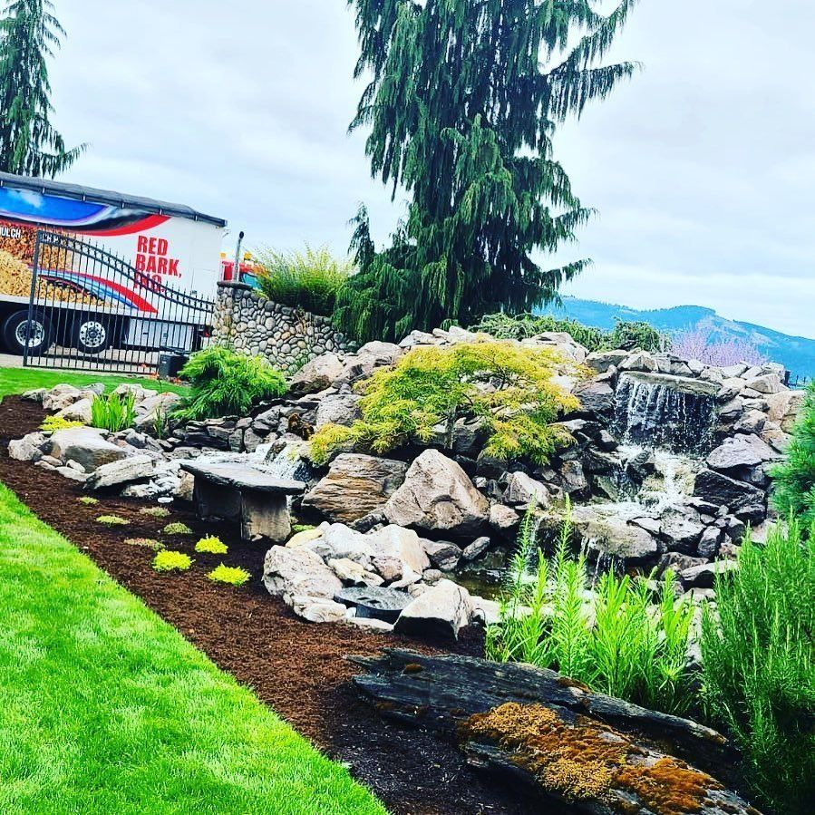 Landscape with waterfall, stone bench, and truck labeled 