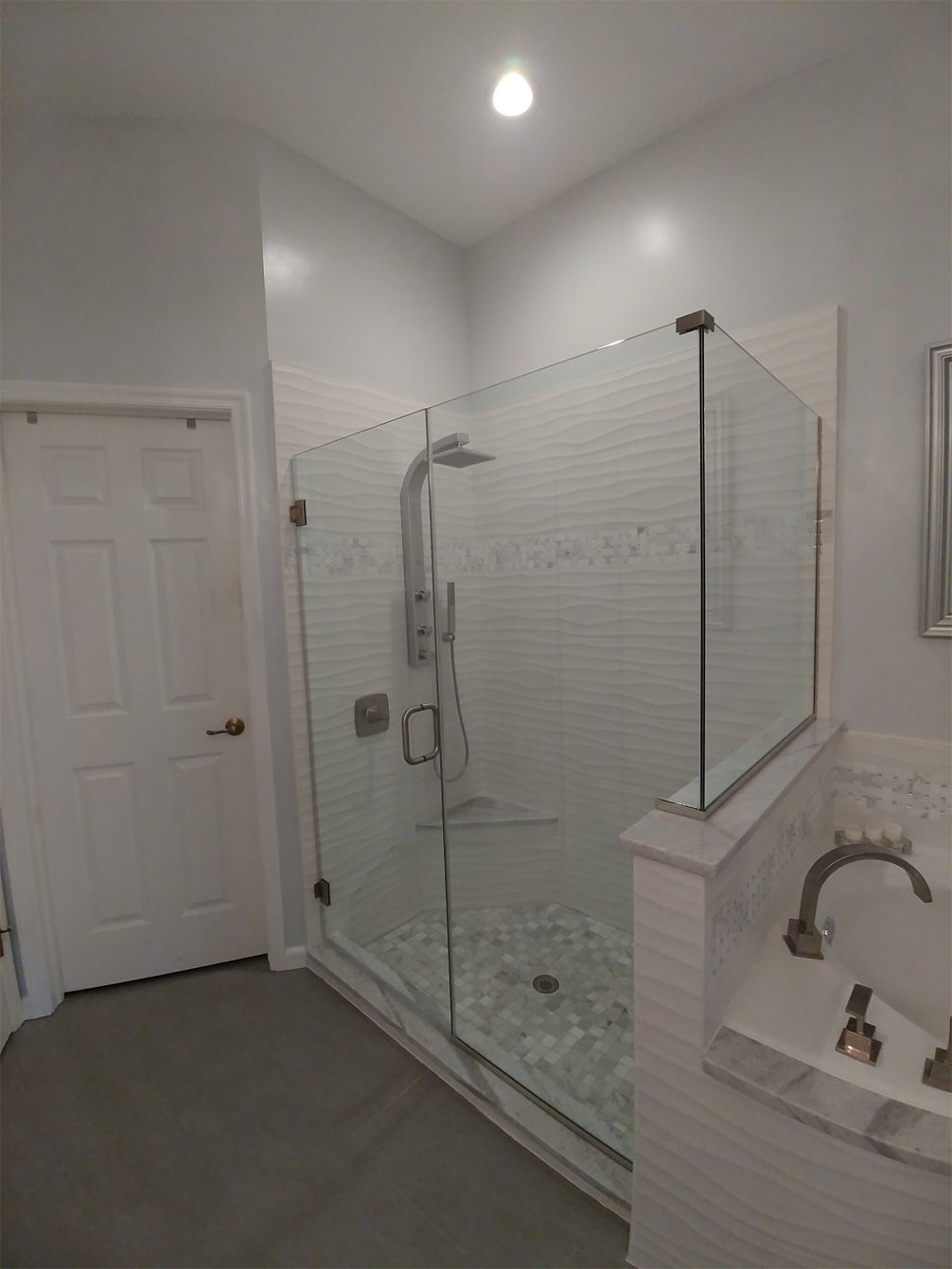 A bathroom with a walk in shower and a bathtub