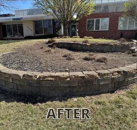 Curved retaining wall in front of a building; soil and mulch inside; 